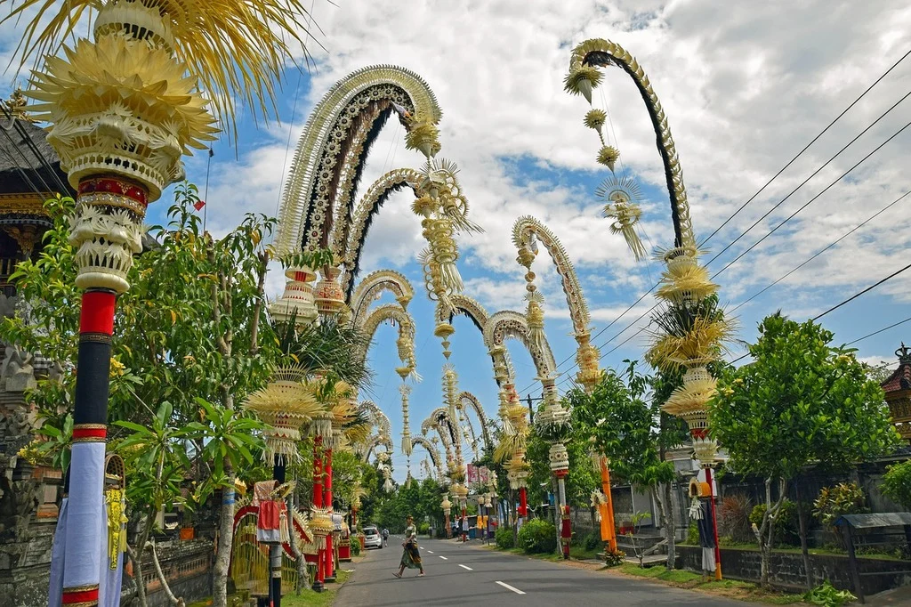 Balinese street adorned with penjor bamboo poles